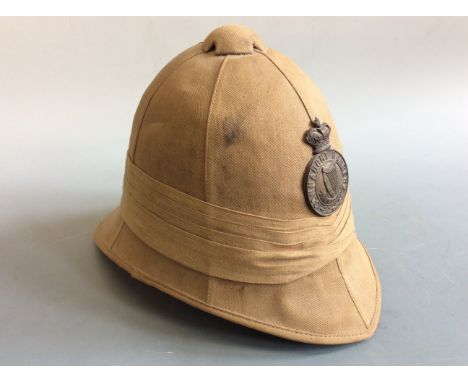 A modern Connaught Rangers Irish pith helmet with badge. IMPORTANT: Online viewing and bidding only. No in person collections