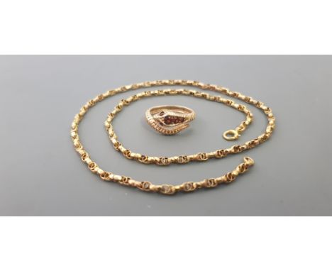 A yellow metal chain,approx. length 40.2cms, approx. weight 5.3gms a snake style twist ring, with red garnet, ring size K mar