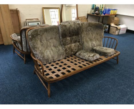 An Ercol four piece suite, three seater missing cushions. IMPORTANT: Online viewing and bidding only. No in person collection