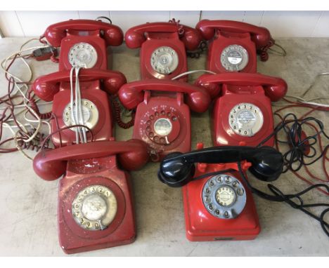 Eight red rotary dial telephones, one with black receiver. IMPORTANT: Online viewing and bidding only. No in person collectio
