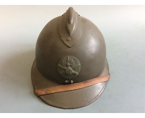 A French World War Two Adrian helmet. IMPORTANT: Online viewing and bidding only. No in person collections, an additional cha