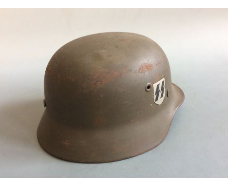 A German World War Two replica helmet. IMPORTANT: Online viewing and bidding only. No in person collections, an additional ch