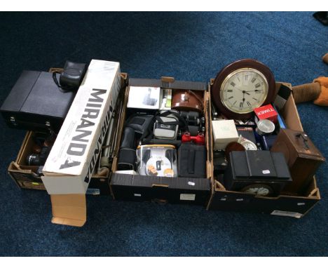 Three boxes of various clocks, binoculars, tripod, cameras, etc. IMPORTANT: Online viewing and bidding only. No in person col