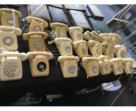 23 cream and yellow rotary dial telephones, one missing dial face. IMPORTANT: Online viewing and bidding only. No in person c