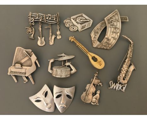 Nine Jonette Jewelry Company music and theatre pin brooches, including piano, cello, drums, guitar and record player. IMPORTA