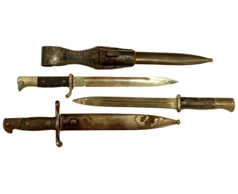 Three German Second World War bayonets, two with scabbards, one with leather holster, various markings, one unable to be remo