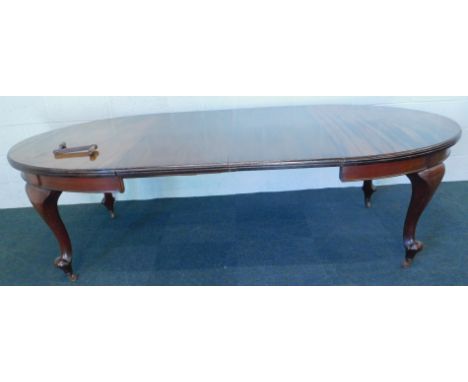 An early 20thC mahogany extending dining table, the oval top on cabriole legs, ceramic castors, two loose leaves, 121cm x 250