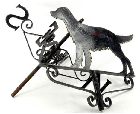 An ebonised wrought iron weather vane, decorated with a Gordon Setter, 74cm W.