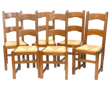 A set of six reclaimed oak ladder back dining chairs, each with a rush seat on square section legs, with stretchers.