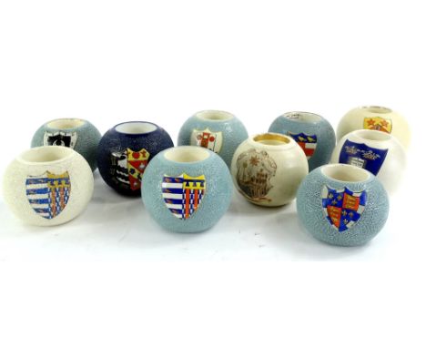 A collection of late 19th/early 20thC ceramic match strikes, each decorated with a crest, to include makers such as Macintyre