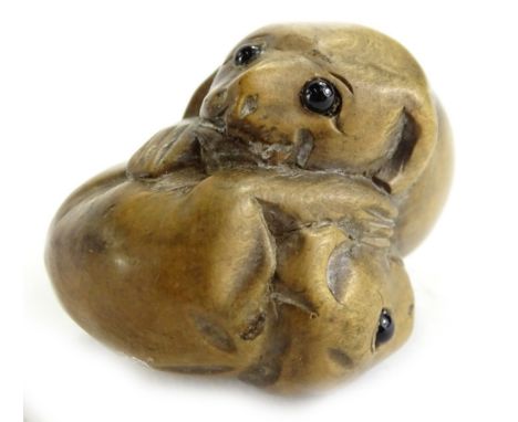 A Japanese wooden netsuke, carved in the form of two rats, each with glass eyes, 4cm W.