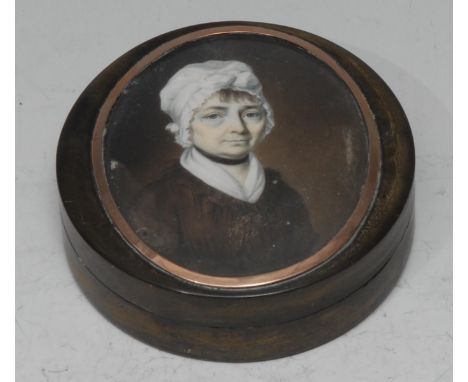 An early 19th century horn and tortoiseshell circular table snuff box, the cover set with a portrait miniature of a lady wear