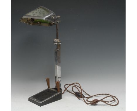 An Art Deco chromium-plated desk lamp, the shade decorated with sun rays through clouds, the base with pen holders and notepa