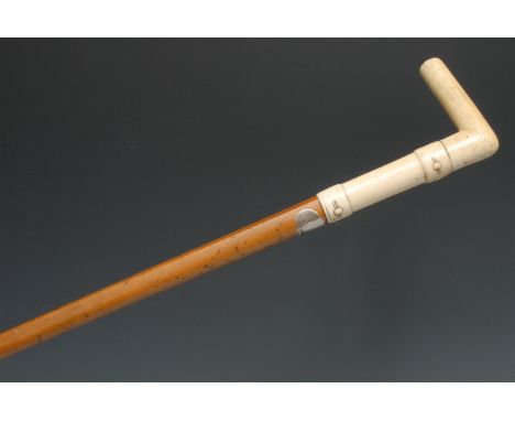 A 19th century gentleman's novelty walking stick, the L-shaped ivory handle carved with faux buttoned straps, malacca cane, 8