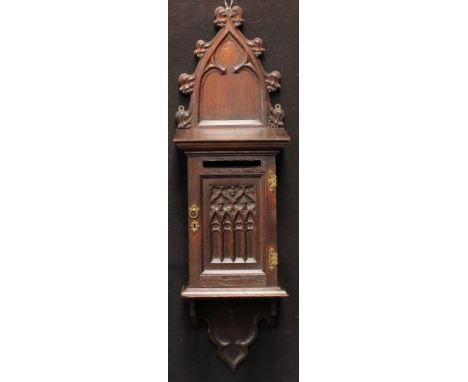 A 19th century Gothic Revival oak wall mounted country house post box, shaped cresting, moulded cornice above a rectangular d