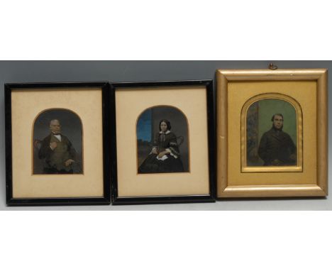 Photography - a pair of 19th century tinted ambrotype portraits, of a lady and gentleman, seated, arched mounts, 9cm x 7cm; a