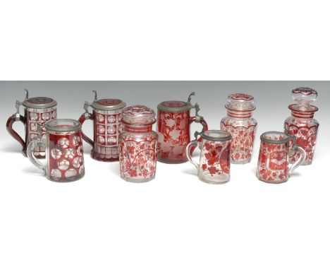 A 19th century Bohemian ruby glass stein, intaglio cut with a king making a toast, on a ground of vine and tendrils, pewter m