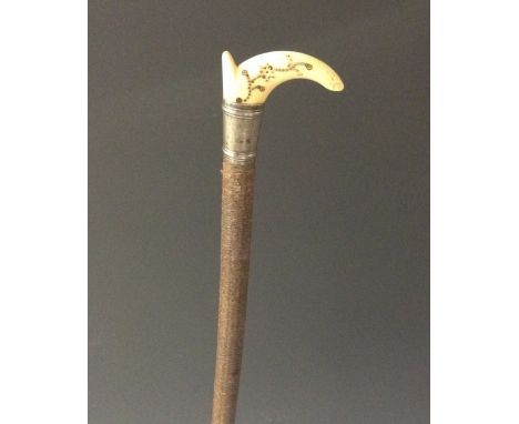 A rare Queen Anne silver-mounted ivory and piqué riding crop, tau-shaped grip typically inlaid with pinwork, 85cm long, c. 17