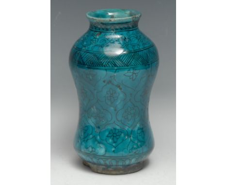 A Middle Eastern albarello, the turquoise glaze decorated in black with stylised lotus, 21cm high 