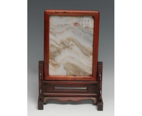 A Chinese hardwood table screen, the dreamstone panel with inscription and red seal, shaped apron, 29cm high, 19cm wide 