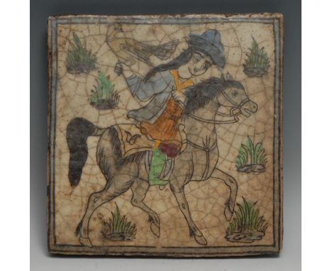 A Qajar tile, painted with a Persian falconer on horseback, 24.5cm x 24cm, 19th century 