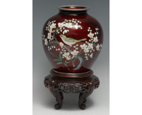 A Japanese cloisonné enamel ovoid vase, decorated in polychrome with a bird and a branch of blossom on a textured red ground,