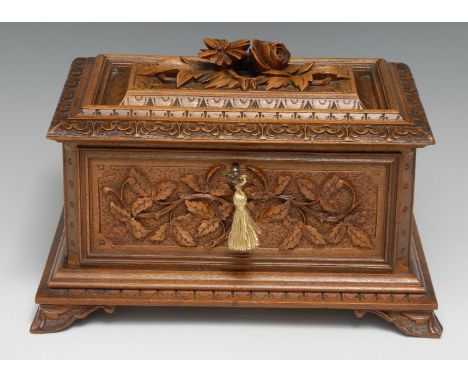 A Black Forest table-top jewellery casket, hinged cover enclosing a lift-out tray fitted with pocket watch stand and moss vel