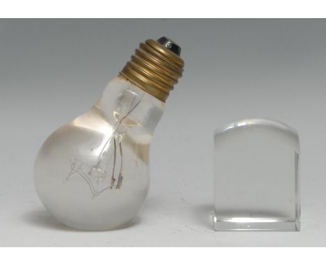 An early to mid-20th century novelty glass desk weight, as a light bulb, 9cm high; a domed square desktop/map reading magnify