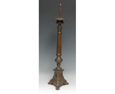 A North European pricket candlestick, compressed campana sconce above a fluted pillar, the triform base with vignettes of Chr