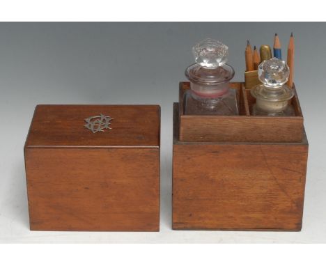 An early 20th century mahogany rectangular travelling decanter box, the push fitting cover enclosing graduated spirit bottles