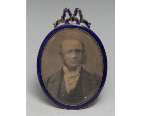 An early 20th century blue enamel oval easel portrait miniature or photograph frame, ribbon cresting, 8.5cm high, c.1910 