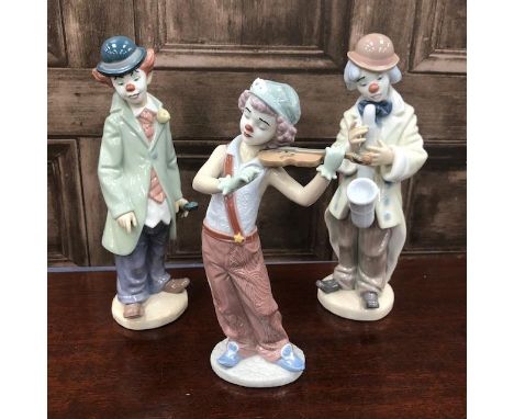 LLADRO CLOWN MUSICIAN FIGURE, playing a saxophone, 23cm high, along with two other Lladro clown musician figures (3)