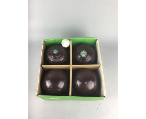 SET OF FOUR LAWN BOWLS, in vintage leather case, along with three other sets of lawn bowls and bags