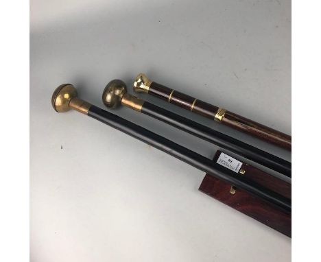 PAIR OF WALKING STICKS, one with a compass top, the other with clock top, each screws in two sections and with a carry case, 