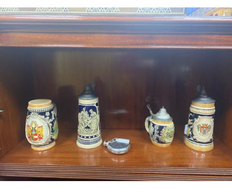 FOUR GERMAN CERAMIC TANKARDS, along with a hip flask with Celtic design (5)