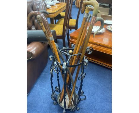 WROUGHT IRON STICK STAND, with twist and spiral forms, along with various walking sticks