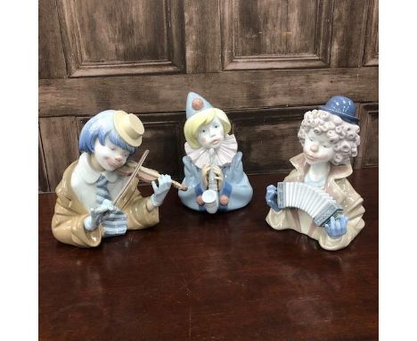 LLADRO CLOWN FIGURE, playing an accordion, 19cm high, along with two other Lladro clown musicians (3)