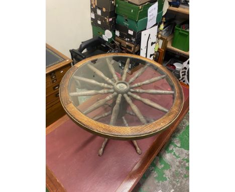 A Mid-Century Coffee Table in the form of a Cartwheel with Glass Top. Height: Diameter: