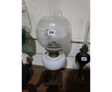 A Metallic Based Oil Lamp With Milk Glass Reservoir
