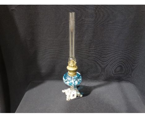 A Square Metal Based Oil Lamp With Enamel Painted Blue Glass Reservoir