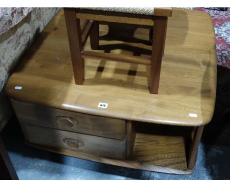     An Ercol Light Oak Finish Magazine Table                                        