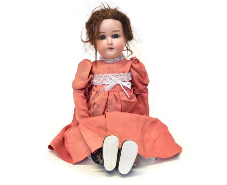 Armand Marseille doll in peach pink dress with marks to the back of her neck, sleepy eyes, articulated joints, bisque head an