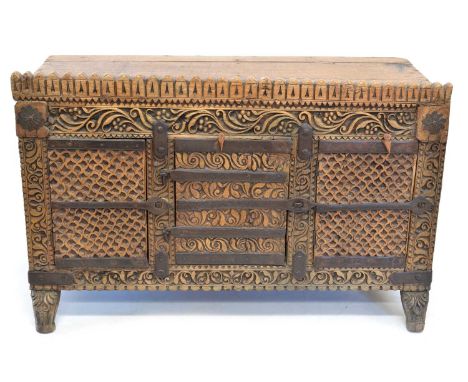 Early 20th century Indian chipped carved side cupboard, plank top with gallery, front with three doors, each with chip carvin