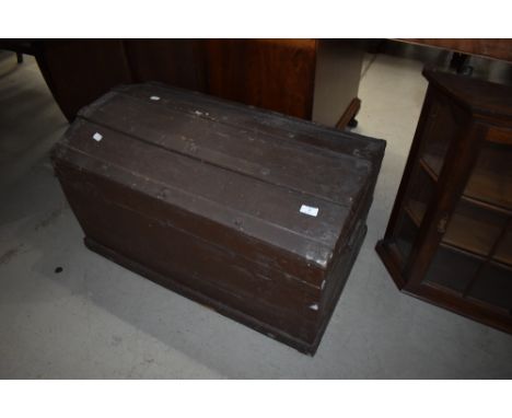 An antique dome top travel trunk