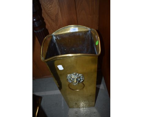 A vintage brass stick stand having lion mask handles