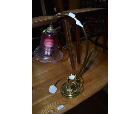 A brass and glass table lamp in the style of Adrian Sankey