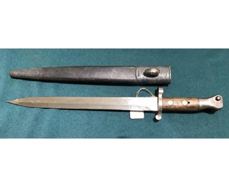 A VICTORIAN 1888 PATTERN BAYONET AND SCABBARD BY WILKINSON.  An 1888 pattern bayonet with a 30.5cm double edged pointed blade