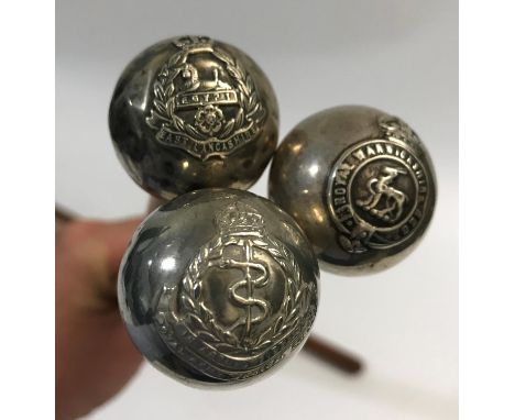 THREE SILVER TOPPED MILITARY CANES AND A LEATHER BATON. Three silver topped Regimental canes, Royal Warwickshire Regiment (Bi