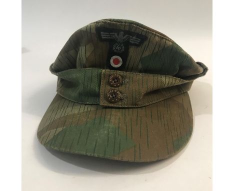 A GERMAN ARMY CAMOUFLAGE FIELD CAP. An M43 Pattern German Army field cap in 'splinter camouflage' pattern fabric, the front w