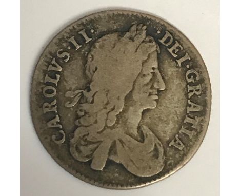 A CHARLES II SHILLING. A Charles II Shilling dated 1663, first draped bust r, reverse with crowned cruciform shields and inte